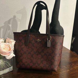 Brand new mini tote brown and dark red (burgundy) in color. Tags still on bag.